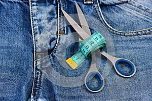 Making clothes and design concept: scissors wound around measure tape