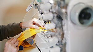 Making clothes. Woman works on sewing machine. Focus on cloth