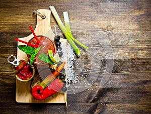 Making cocktail with ingredients on wooden background . Free space for text.