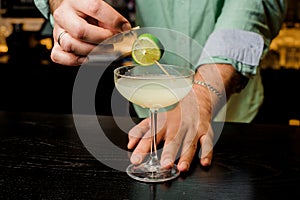 Making the cocktail with lime close up