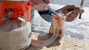 Making coffee in Cezve at winter mountains