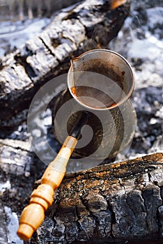 Making coffee in the fireplace on camping or hiking in the natu