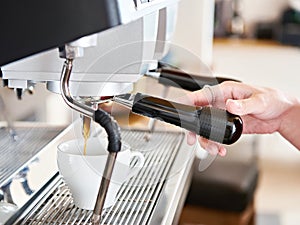 Making coffee in machine in cafe bar