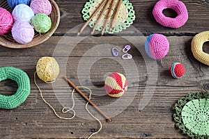 Making colored crochet balls. Toy for babies and toddlers to learn mechanical skills and colors. On the table threads, needles,