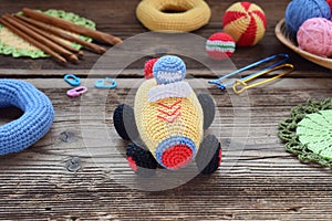Making colored crochet racing car. Toy for babies and toddlers to learn mechanical skills and colors. On the table threads,