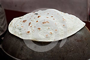 Making cooking Indian flat bread Rumali roti, chapathi, fulka, paratha made of whole wheat