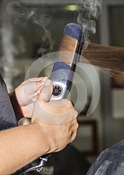 Making curles with hair iron at the hairdressers