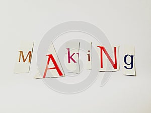 Making - Cutout Words Collage Of Mixed Magazine Letters with White Background