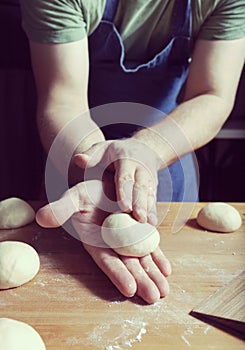 Making daugh balls on the wooden table to bake buns