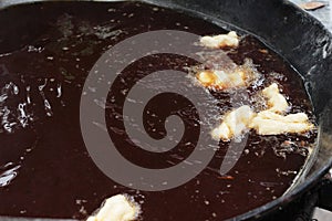 Making deep-fried dough stick in market.