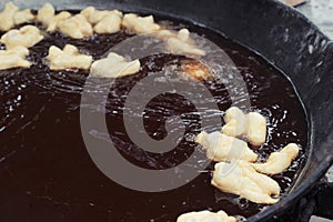 Making deep-fried dough stick in market.