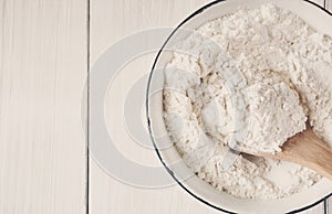 Making dough, baking. Bowl with flour on wood desk