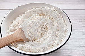 Making dough, baking. Bowl with flour on wood desk