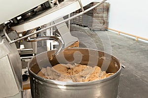 Making dough for bread in a kneader in a bakery. Industrial mixer for kneading dough. One of the stages of making bread dough