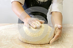 Making dough by male hands at bakery