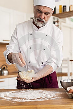 Making dough by male hands at bakery