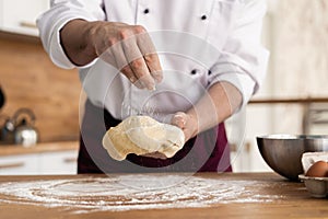 Making dough by male hands at bakery