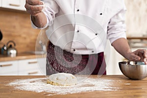 Making dough by male hands at bakery