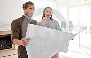 Making dreams a reality. Shot of two young architects looking at building plans on site.