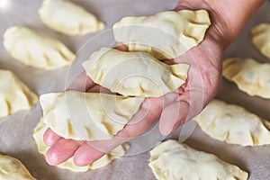 Making dumplings filled with sour cherry with sugar