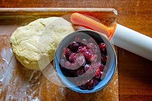 Making dumplings filled with sour cherryor cake