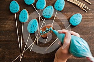 Making easter blue cake pops. Culinary decor.
