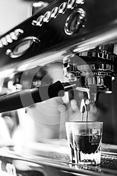 Making espresso coffee close up detail with modern machine