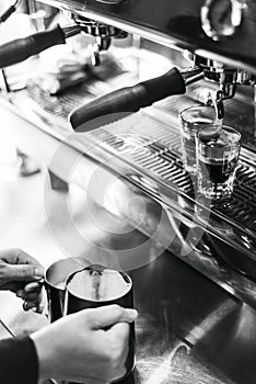 Making espresso coffee close up detail with modern machine