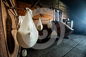 Making fresh homemade cottage cheese in cheesecloth in a wooden house photo