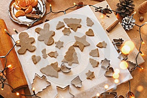 Making gingerbread cookies, Christmas holiday tradition. Raw gingerbread dough and metal cutters