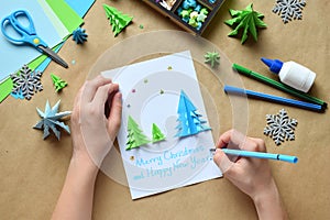 Making greeting card with origami 3D Xmas tree from paper. Merry Christmas and Happy New Year decoration. Childrens DIY concept.