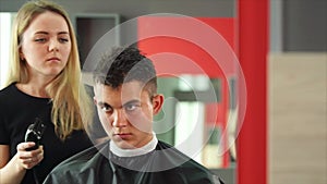 Making haircut. Young handsome man getting haircut by hairdresser