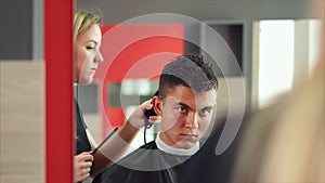 Making haircut. Young handsome man getting haircut by hairdresser
