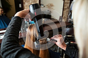 Making hairstyle using hair dryer.