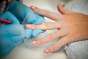 Making hand nails in a professional hand care salon - manicure