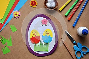 Making of handmade Easter decoration. Child made greeting card in egg shape. Childrens DIY concept, gift with your own hands.