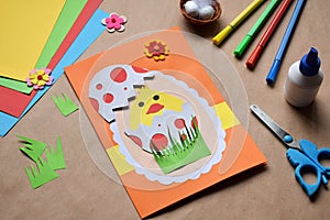 Making of handmade Easter decoration. Child made greeting card in egg shape. Childrens DIY concept, gift with your own hands.