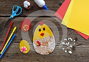 Making of handmade Easter decoration. Child made greeting card from eggshell. Childrens DIY concept, gift with your own hands.