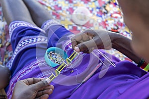 Making of handmade jewellery. Masai african women hands, top view, close up. Island of Zanzibar, Tanzania, Africa