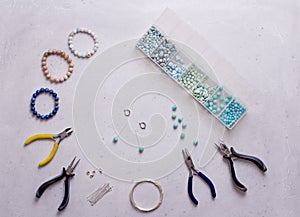 Making of handmade jewellery. Top view. Beads, tools for creating jewelry. Preparation for handmade. Create jewelry, bracelets