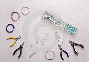 Making of handmade jewellery. Top view. Beads, tools for creating jewelry. Preparation for handmade. Create jewelry, bracelets