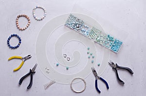 Making of handmade jewellery. Top view. Beads, tools for creating jewelry. Preparation for handmade. Create jewelry, bracelets