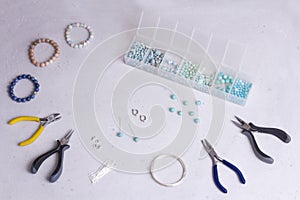 Making of handmade jewellery. Top view. Beads, tools for creating jewelry. Preparation for handmade. Create jewelry, bracelets