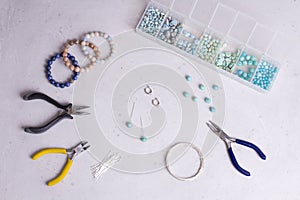 Making of handmade jewellery. Top view. Beads, tools for creating jewelry. Preparation for handmade. Create jewelry, bracelets