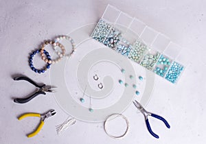 Making of handmade jewellery. Top view. Beads, tools for creating jewelry. Preparation for handmade. Create jewelry, bracelets