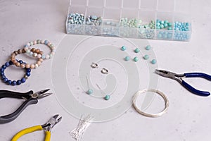 Making of handmade jewellery. Top view. Beads, tools for creating jewelry. Preparation for handmade. Create jewelry, bracelets