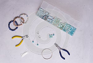 Making of handmade jewellery. Top view. Beads, tools for creating jewelry. Preparation for handmade. Create jewelry, bracelets