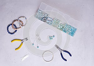 Making of handmade jewellery. Top view. Beads, tools for creating jewelry. Preparation for handmade. Create jewelry, bracelets