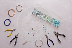 Making of handmade jewellery. Top view. Beads, tools for creating jewelry. Preparation for handmade. Create jewelry, bracelets