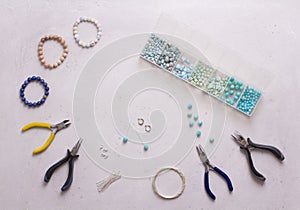 Making of handmade jewellery. Top view. Beads, tools for creating jewelry. Preparation for handmade. Create jewelry, bracelets